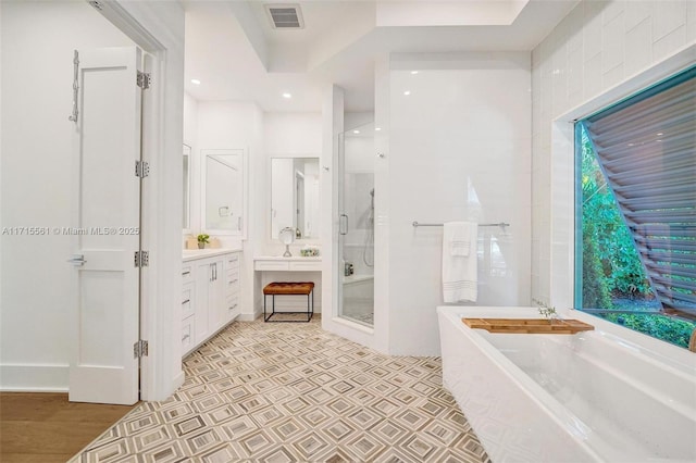 bathroom featuring hardwood / wood-style flooring, vanity, and shower with separate bathtub