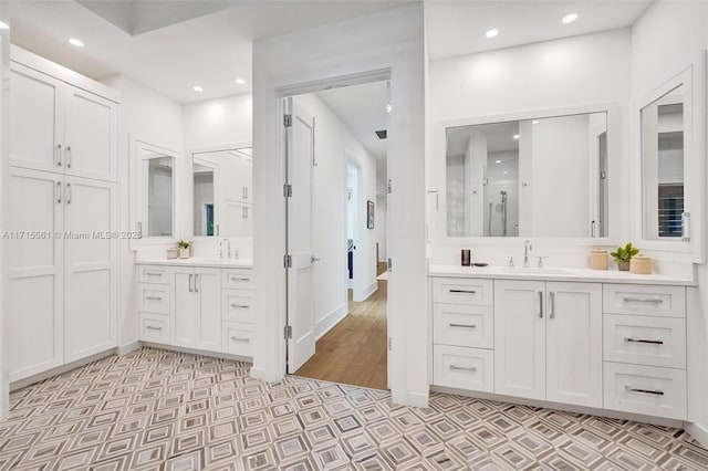 bathroom featuring vanity, wood-type flooring, and a shower with shower door