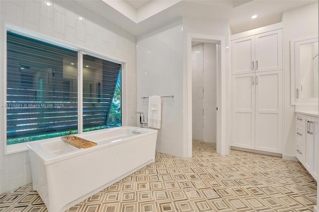 bathroom with vanity and a bathing tub