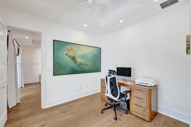 office with ceiling fan and light hardwood / wood-style flooring