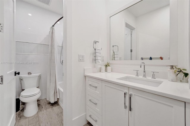 full bathroom with shower / tub combo, vanity, hardwood / wood-style floors, and toilet