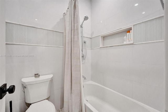 bathroom featuring shower / tub combo with curtain, tile walls, and toilet