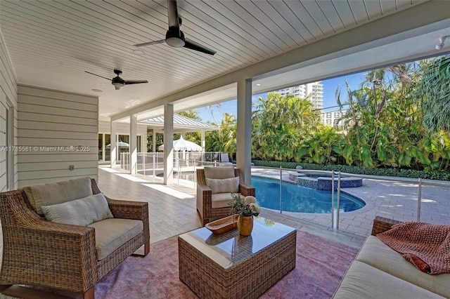 view of swimming pool featuring an in ground hot tub, an outdoor hangout area, and a patio area