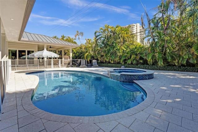 view of pool featuring an in ground hot tub, ceiling fan, and a patio area