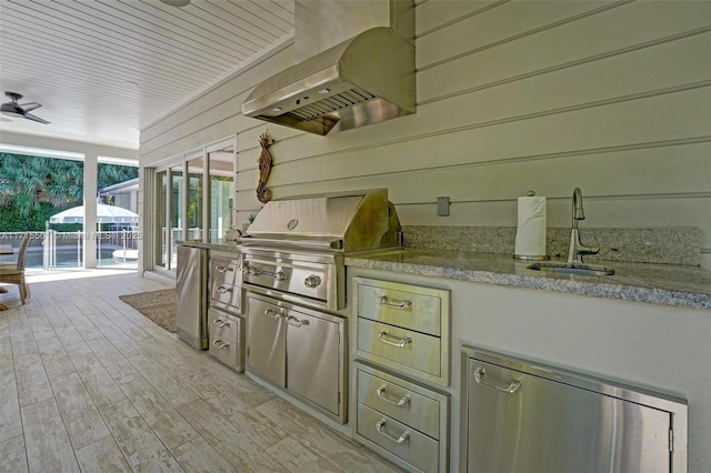 view of patio featuring an outdoor kitchen, area for grilling, and sink