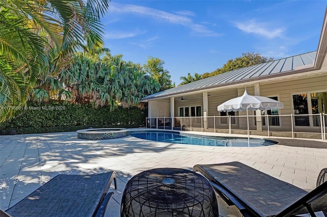 view of pool with a patio, ceiling fan, and an in ground hot tub