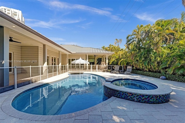 view of swimming pool with an in ground hot tub, ceiling fan, and a patio area