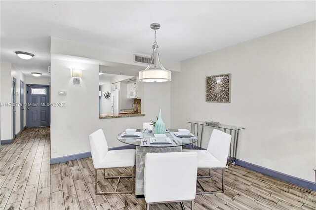 20416 NE 34th Ct Unit 17, Aventura, FL 33180 - dining room with light wood-style floors and baseboards