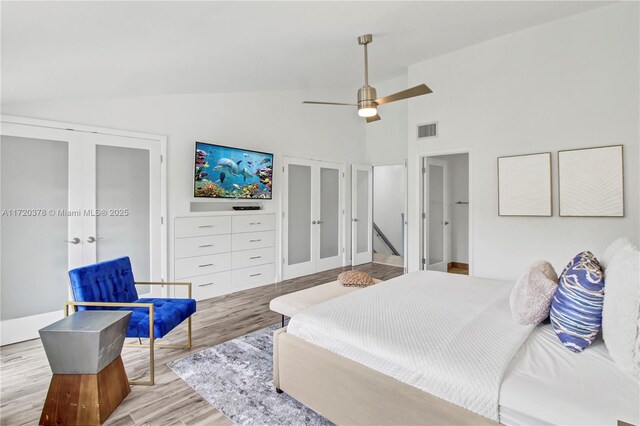 20416 NE 34th Ct Unit 17, Aventura, FL 33180 - bedroom featuring french doors, wood finished floors, high vaulted ceiling, and a ceiling fan