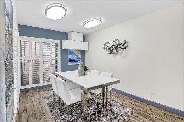 20416 NE 34th Ct Unit 17, Aventura, FL 33180 - dining space with light wood-type flooring and baseboards