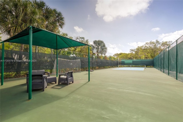 view of property's community with tennis court