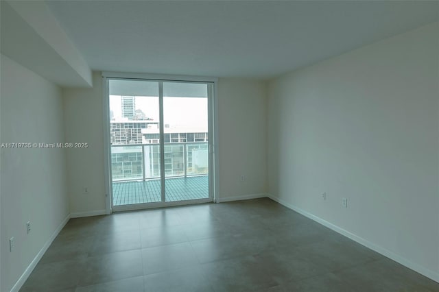 unfurnished room featuring expansive windows