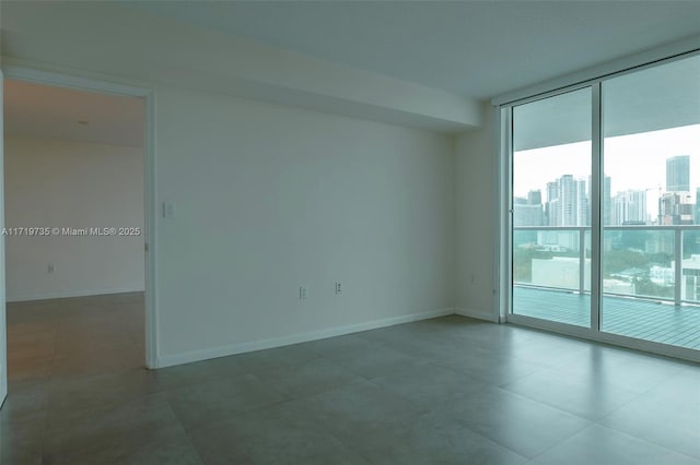 unfurnished room with floor to ceiling windows