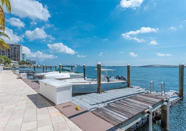 view of patio featuring a water view and a boat dock