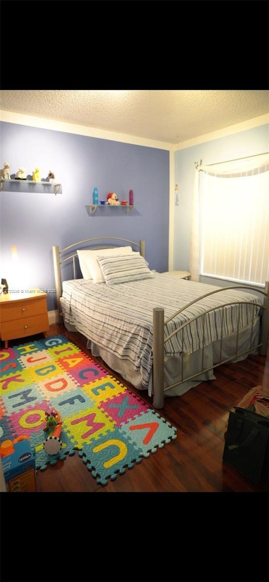 bedroom featuring dark hardwood / wood-style flooring