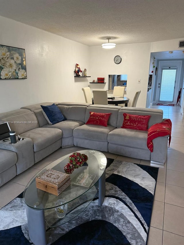 living room with light tile patterned floors and a textured ceiling