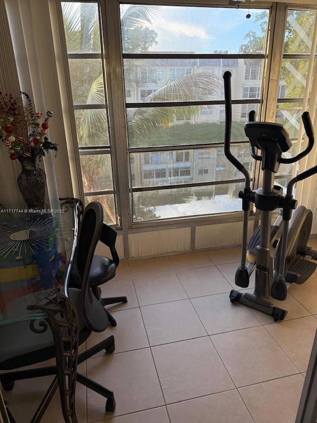 exercise room featuring light tile patterned flooring