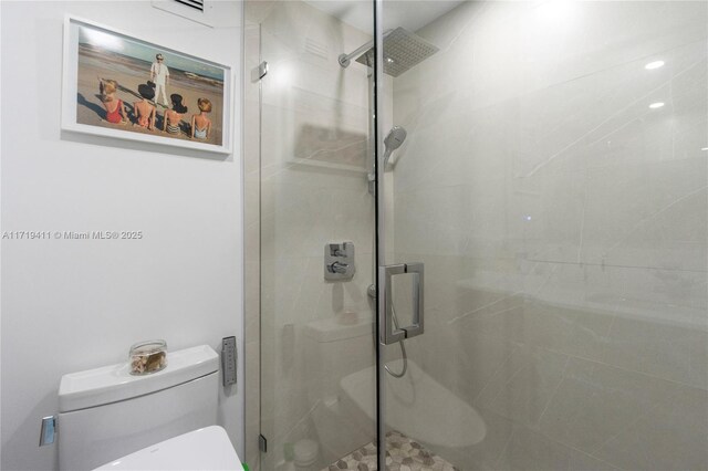 bathroom featuring toilet and walk in shower