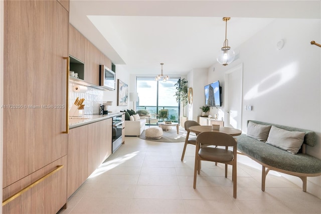 interior space with light tile patterned floors and an inviting chandelier