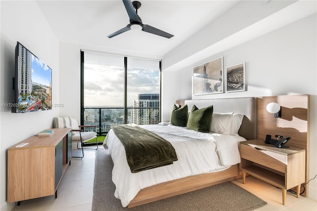 bedroom with access to exterior, ceiling fan, expansive windows, and light tile patterned floors