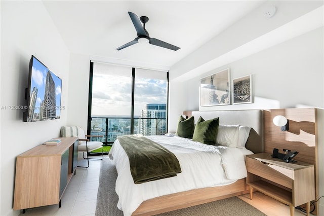 bedroom featuring access to outside, ceiling fan, expansive windows, and light tile patterned floors