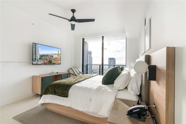 bedroom featuring ceiling fan and floor to ceiling windows