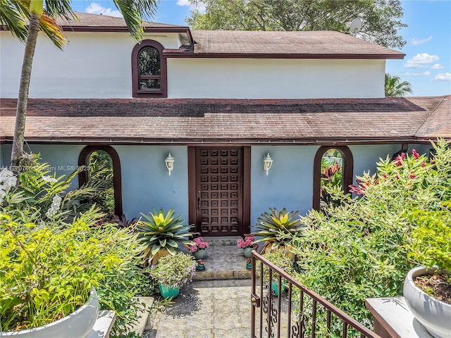 1524 39th St, West Palm Beach, FL 33407 - view of front facade featuring stucco siding and roof with shingles
