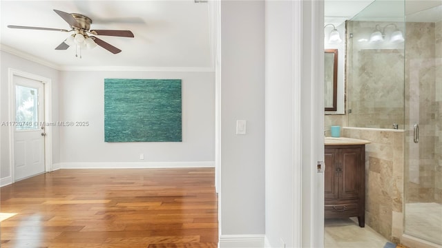1524 39th St, West Palm Beach, FL 33407 - full bathroom with a stall shower, a ceiling fan, ornamental molding, wood finished floors, and vanity