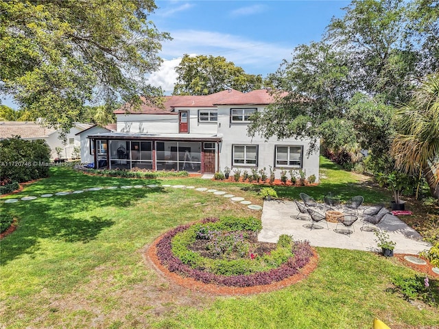 1524 39th St, West Palm Beach, FL 33407 - rear view of property featuring a sunroom, a patio, a yard, stucco siding, and a fire pit