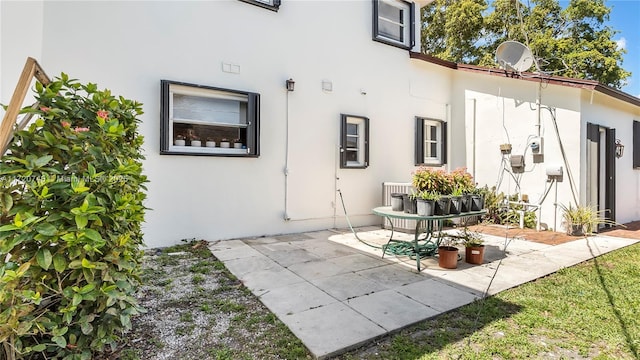 1524 39th St, West Palm Beach, FL 33407 - rear view of house with stucco siding and a patio