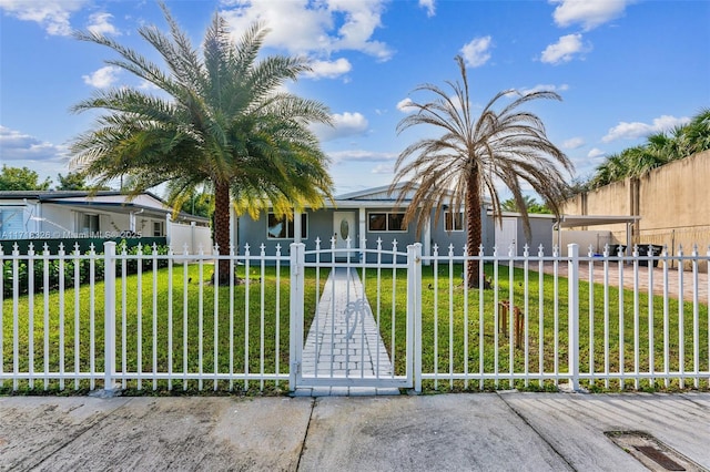 view of front of property featuring a fenced front yard, a gate, and a front lawn