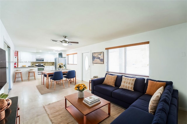 living room featuring plenty of natural light, ceiling fan, and light tile patterned flooring