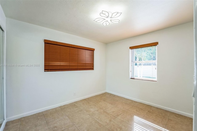 spare room with baseboards