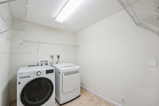 laundry area featuring baseboards, laundry area, and washer and dryer