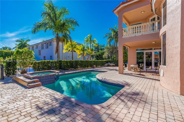 view of pool featuring a patio area and an in ground hot tub