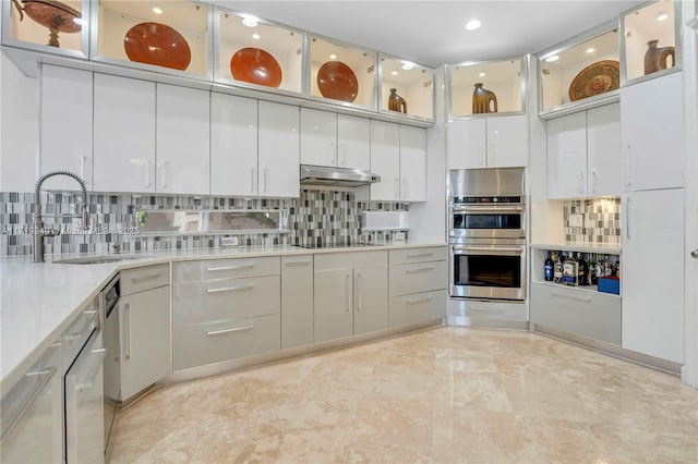 kitchen featuring black electric stovetop, stainless steel double oven, tasteful backsplash, and sink