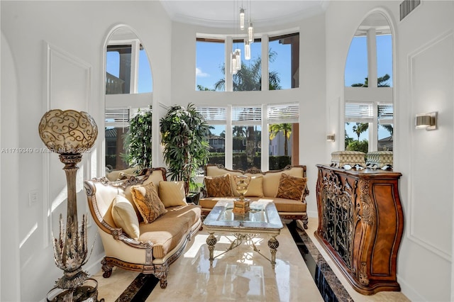 sunroom featuring a healthy amount of sunlight and a notable chandelier