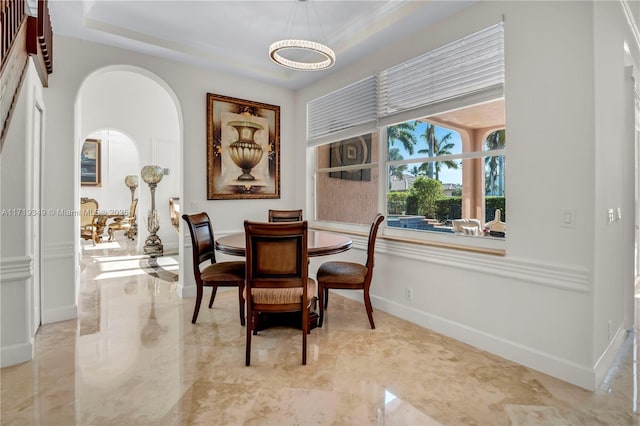 dining space featuring a tray ceiling