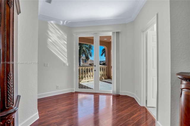 interior space featuring french doors, dark wood-type flooring, and ornamental molding