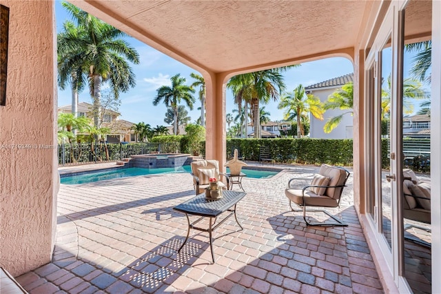 view of patio / terrace featuring a pool with hot tub