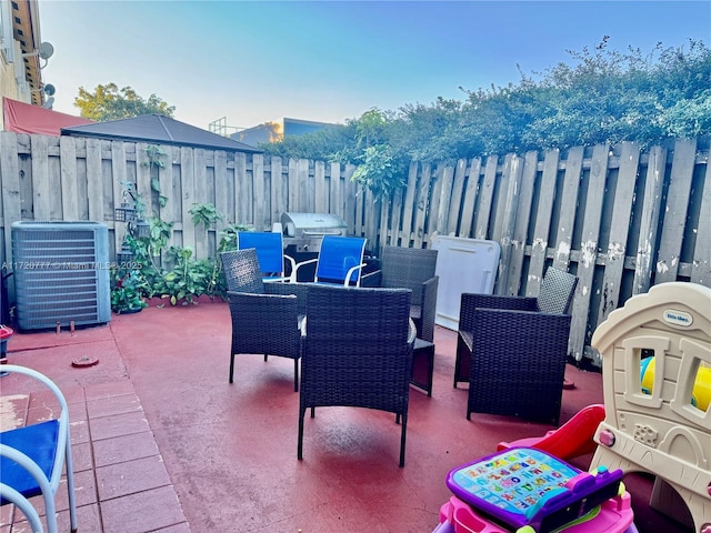 view of patio / terrace with a grill and central air condition unit