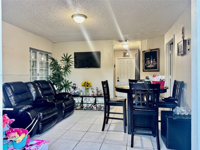 living room with tile patterned flooring and a textured ceiling