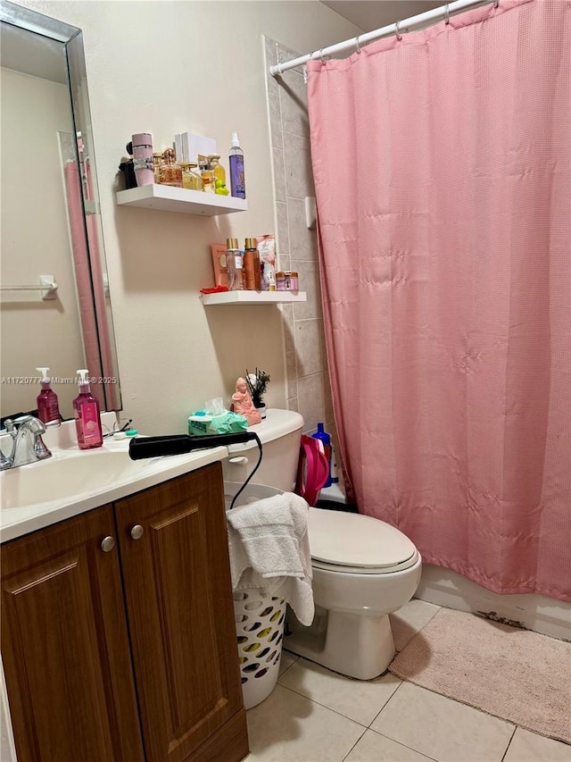 bathroom featuring tile patterned flooring, vanity, and toilet