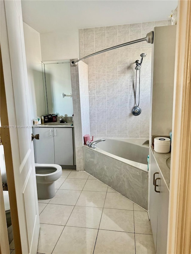 full bathroom with toilet, vanity, tile patterned floors, and tiled shower / bath combo