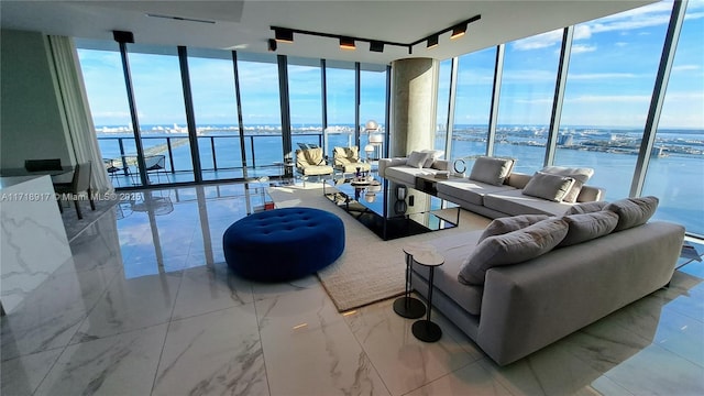 living room with expansive windows and a water view