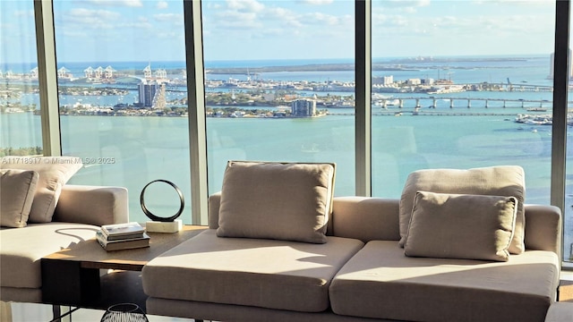 interior space with a water view and floor to ceiling windows