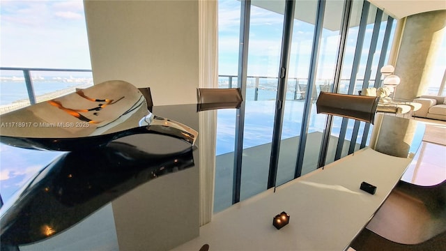 dining space featuring a water view and expansive windows