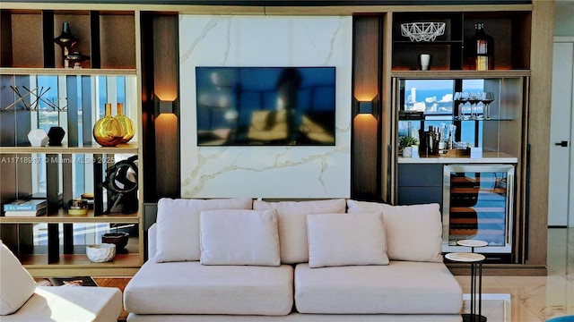 living area featuring marble finish floor and beverage cooler