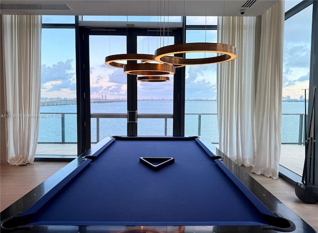 playroom with plenty of natural light, pool table, and a water view