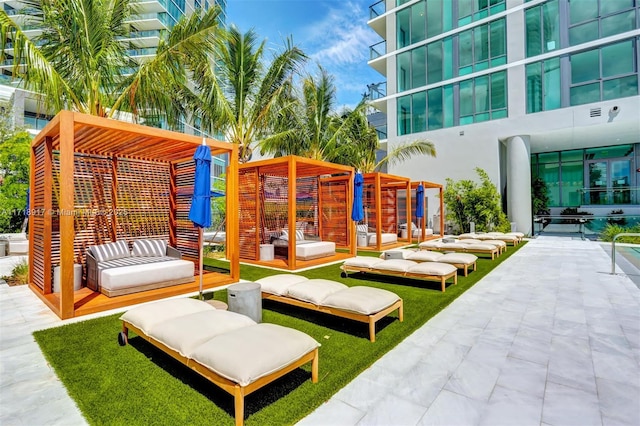 surrounding community featuring a patio area and an outdoor hangout area